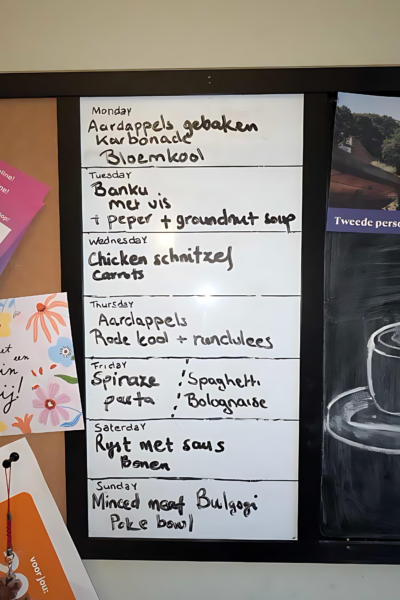 How to make cooking dinner less stressful for working parents Meal plan written on a whiteboard. Doubles as a board pricker and you black board.